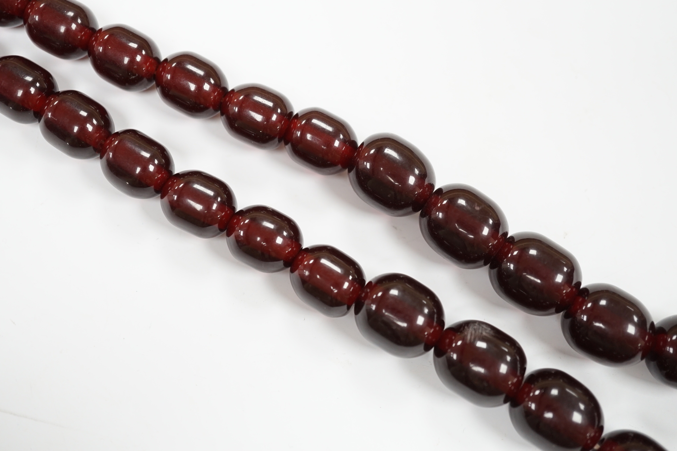 A single strand graduated simulated cherry amber bead necklace, 68cm, gross weight 151 grams.